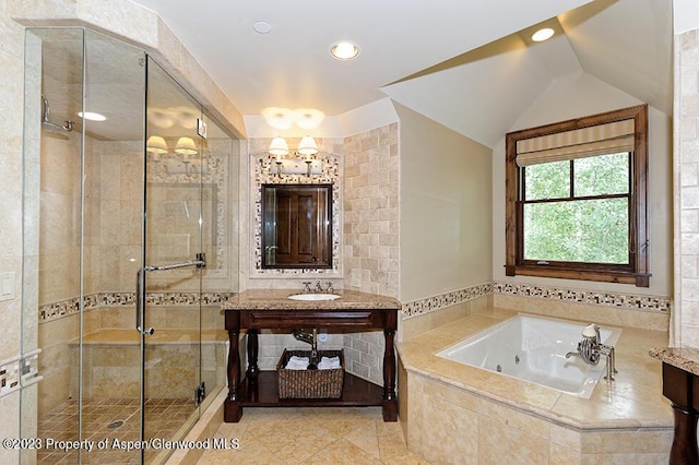 bathroom with tile patterned floors, vanity, a notable chandelier, plus walk in shower, and lofted ceiling