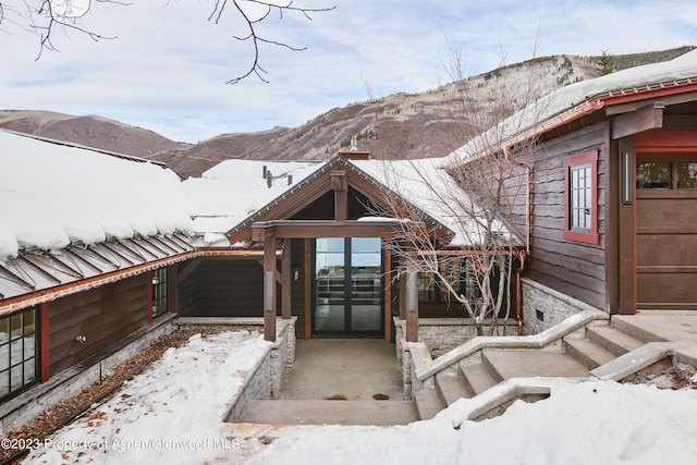 1271 Ute Ave, Aspen, CO 81611 - snow covered property entrance with french doors and a mountain view