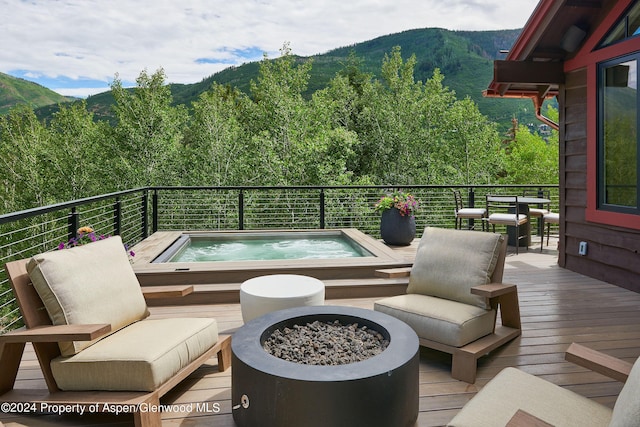 1271 Ute Ave, Aspen, CO 81611 - deck with an outdoor hot tub, a fire pit, and a mountain view