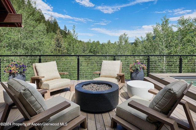 1271 Ute Ave, Aspen, CO 81611 - wooden deck with an outdoor fire pit and a view of trees