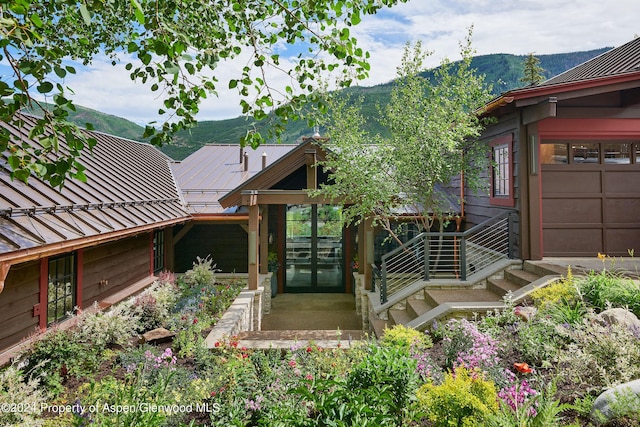 1271 Ute Ave, Aspen, CO 81611 - property entrance with a metal roof, a mountain view, and a standing seam roof