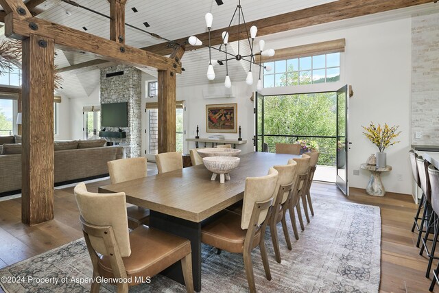 1271 Ute Ave, Aspen, CO 81611 - dining room with high vaulted ceiling, hardwood / wood-style flooring, a chandelier, healthy amount of natural light, and a wooden ceiling with exposed beams