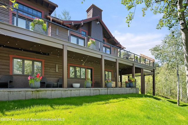 1271 Ute Ave, Aspen, CO 81611 - back of property featuring a balcony, ceiling fan, a lawn, and a chimney