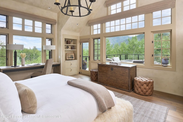 1271 Ute Ave, Aspen, CO 81611 - bedroom featuring high vaulted ceiling, a chandelier, and wood finished floors