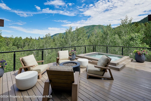 1271 Ute Ave, Aspen, CO 81611 - deck with an outdoor hot tub, a forest view, a mountain view, and a fire pit