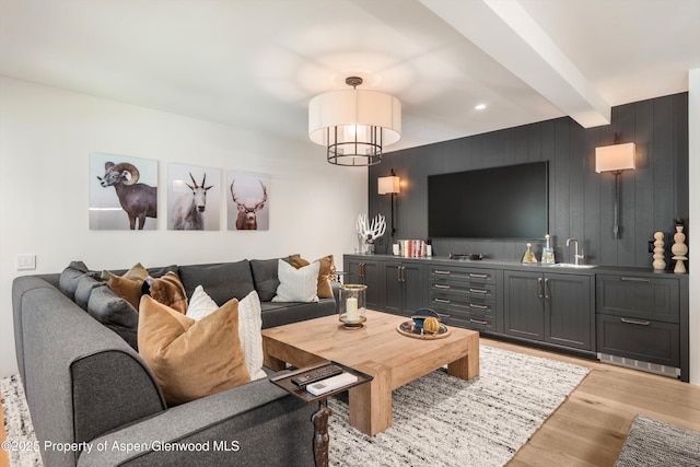 1271 Ute Ave, Aspen, CO 81611 - living room featuring light wood-style flooring, beamed ceiling, and bar