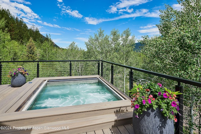 1271 Ute Ave, Aspen, CO 81611 - view of pool featuring an outdoor hot tub and a wooded view