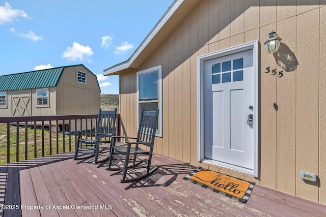 view of exterior entry featuring a deck