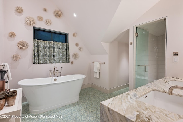 bathroom featuring vanity, vaulted ceiling, and shower with separate bathtub