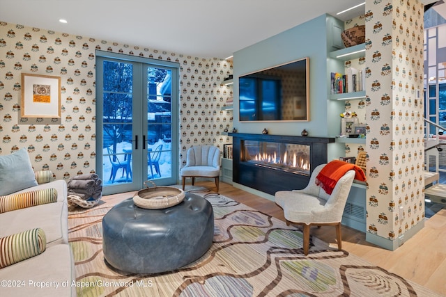 living area featuring hardwood / wood-style floors and french doors