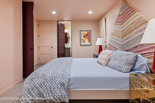 carpeted bedroom featuring ensuite bathroom