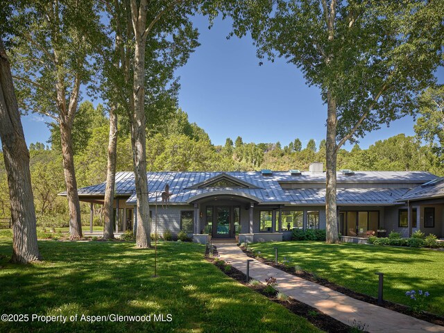 3333 Snowmass Creek Rd, Snowmass, CO 81654 - view of front facade featuring a front lawn, a standing seam roof, and a metal roof