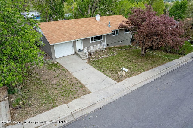 885 Stout St, Craig, CO 81625 - ranch-style house featuring a garage, driveway, a front yard, a porch, and a chimney