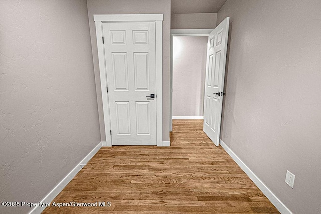 885 Stout St, Craig, CO 81625 - hallway featuring wood finished floors, baseboards, and a textured wall