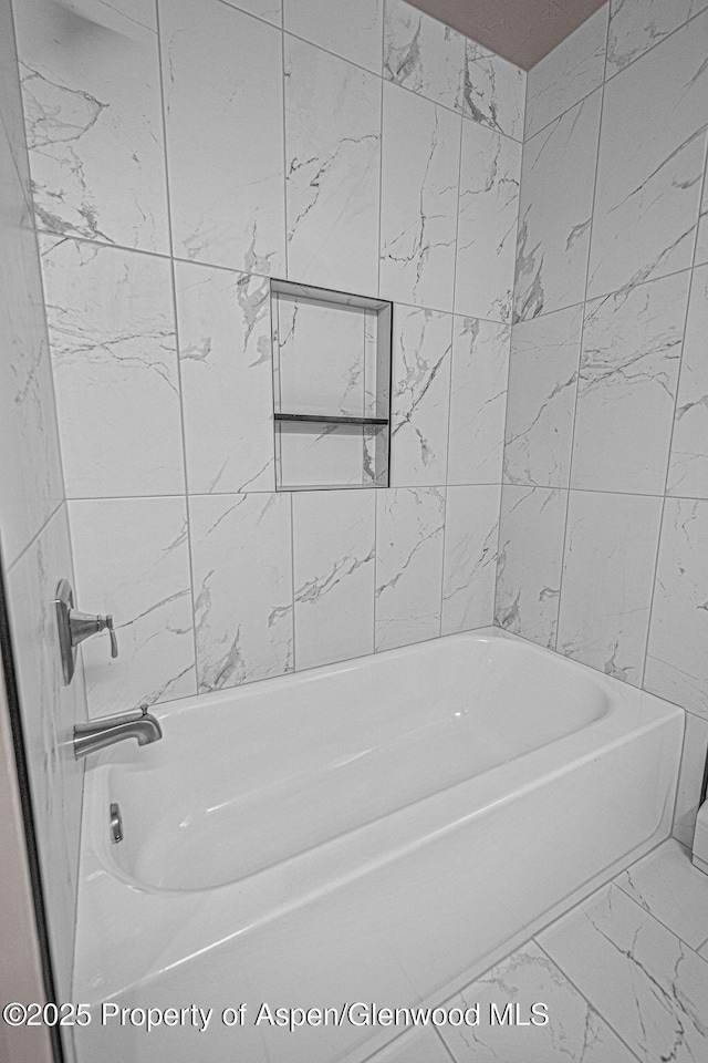 885 Stout St, Craig, CO 81625 - bathroom with marble look tiles and tub / shower combination