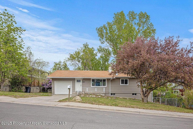 885 Stout St, Craig, CO 81625 - ranch-style house with an attached garage, concrete driveway, and covered porch