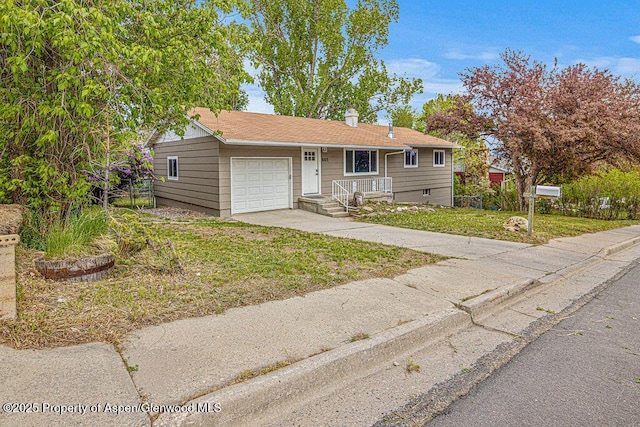 885 Stout St, Craig, CO 81625 - view of front facade featuring an attached garage, driveway, a front lawn, and a chimney