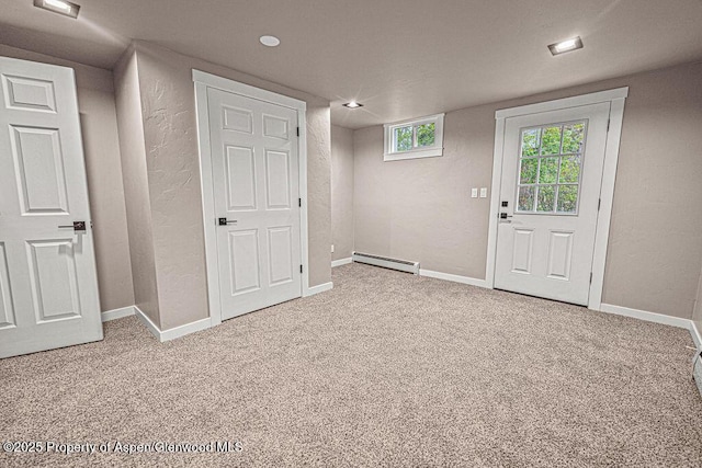 885 Stout St, Craig, CO 81625 - basement with a baseboard heating unit, carpet, a textured wall, baseboards, and recessed lighting