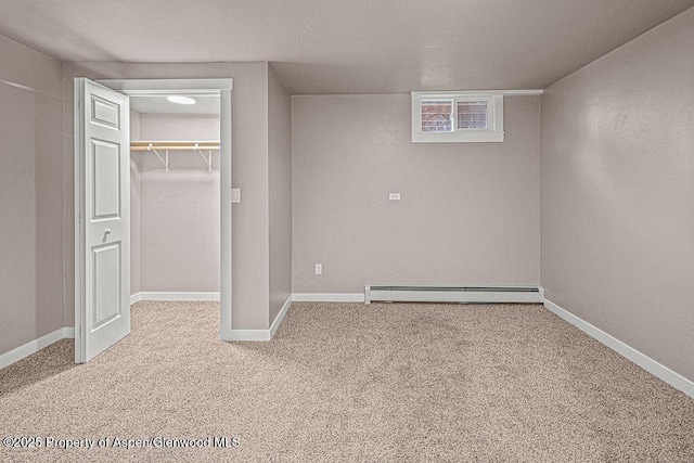 885 Stout St, Craig, CO 81625 - unfurnished bedroom with baseboard heating, carpet, a walk in closet, a closet, and baseboards