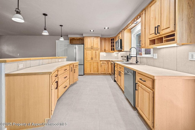 885 Stout St, Craig, CO 81625 - kitchen with appliances with stainless steel finishes, a sink, light countertops, pendant lighting, and glass insert cabinets
