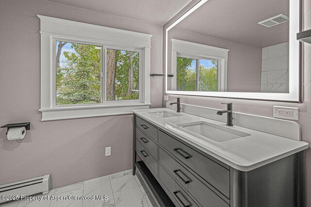 885 Stout St, Craig, CO 81625 - full bathroom featuring a baseboard heating unit, marble finish floors, healthy amount of natural light, and double vanity