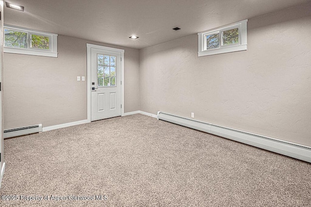 885 Stout St, Craig, CO 81625 - below grade area featuring a baseboard heating unit, a baseboard radiator, carpet, baseboards, and a textured wall