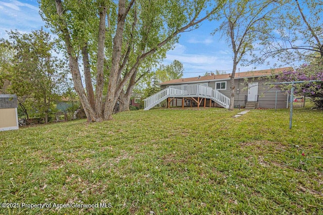 885 Stout St, Craig, CO 81625 - view of grassy yard with stairway, entry steps, and a deck