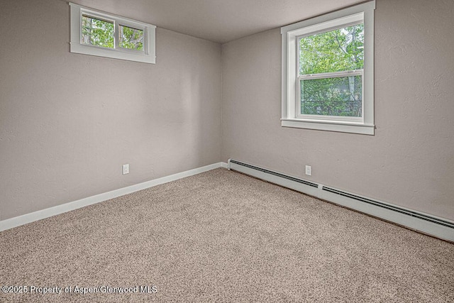 885 Stout St, Craig, CO 81625 - carpeted spare room with baseboard heating, plenty of natural light, and baseboards