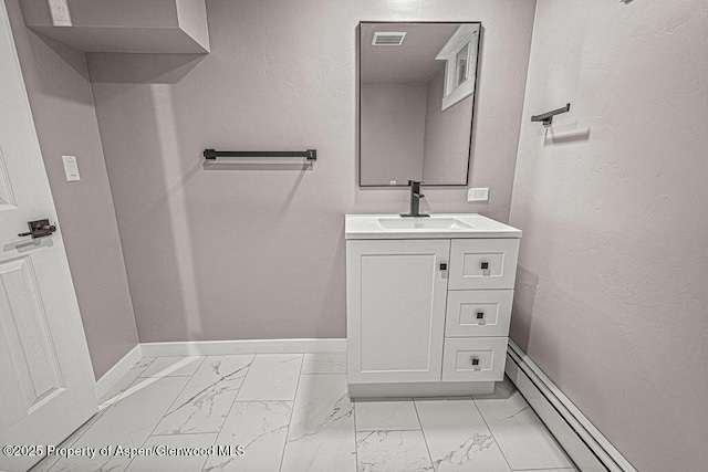 885 Stout St, Craig, CO 81625 - bathroom with marble look tile flooring, baseboards, vanity, and baseboard heating