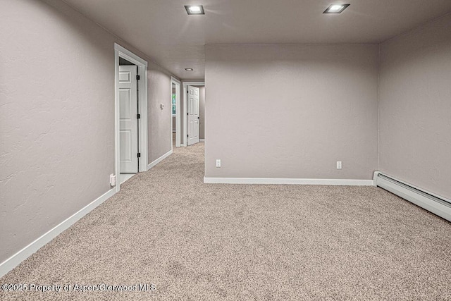 885 Stout St, Craig, CO 81625 - carpeted spare room with baseboards, a baseboard radiator, and a textured wall