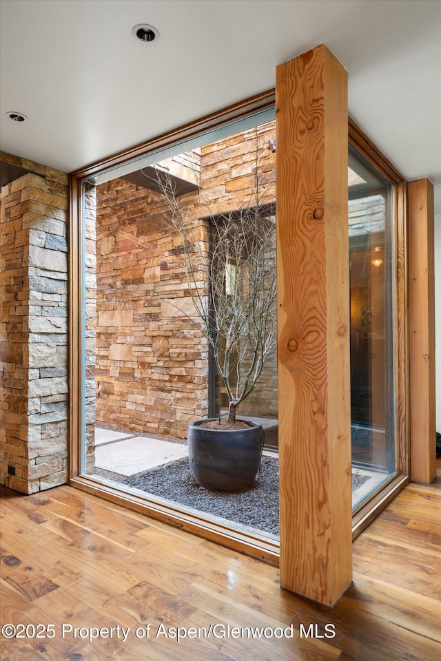 doorway with hardwood / wood-style flooring