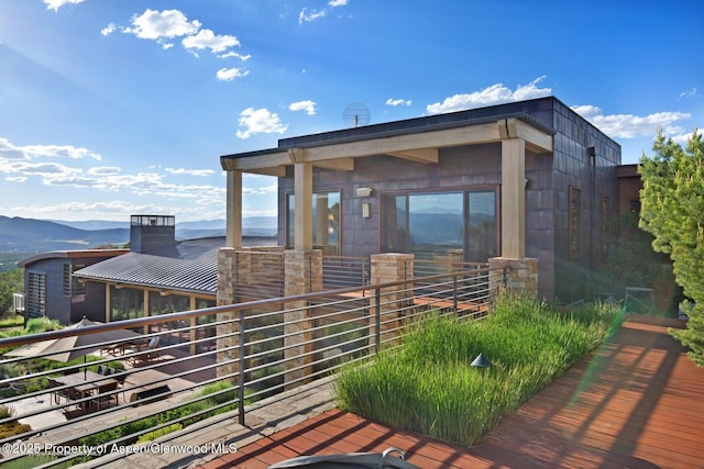 exterior space with a mountain view and a balcony