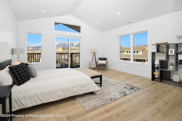 bedroom with lofted ceiling, access to exterior, and light wood-type flooring