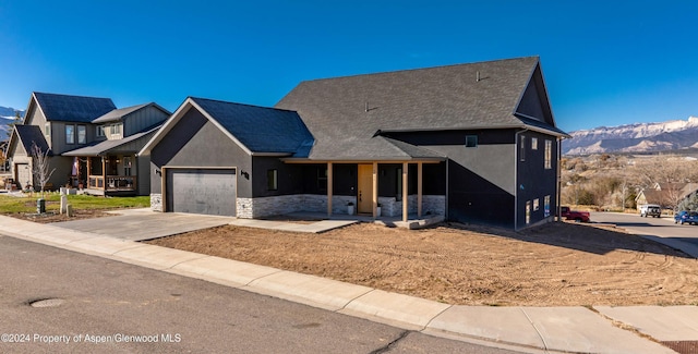 view of front of home featuring a mountain view and a garage