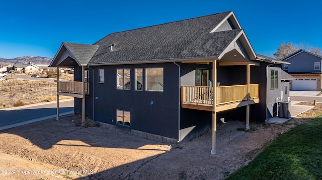 rear view of house featuring a mountain view and cooling unit