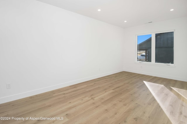 spare room featuring light hardwood / wood-style flooring