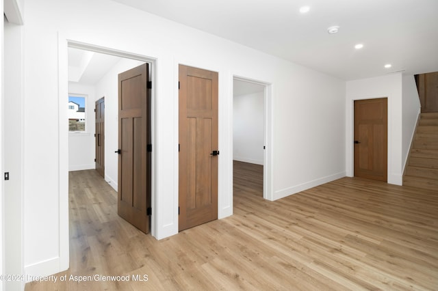 hallway with light hardwood / wood-style flooring