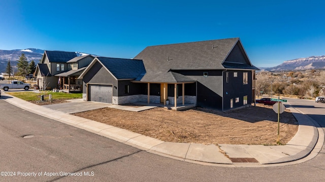 view of front of property with a mountain view and a garage