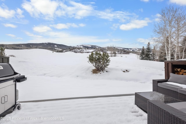 snowy yard featuring a mountain view