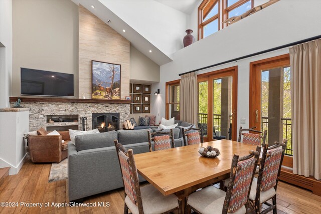 425 Wood Rd Unit 43, Snowmass Village, CO 81615 - dining space featuring high vaulted ceiling, a fireplace, hardwood / wood-style floors, and recessed lighting