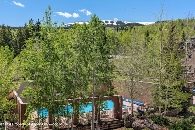 425 Wood Rd Unit 43, Snowmass Village, CO 81615 - view of property featuring a view of trees