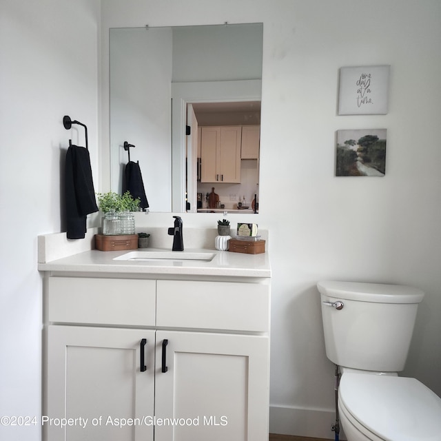 bathroom featuring vanity and toilet