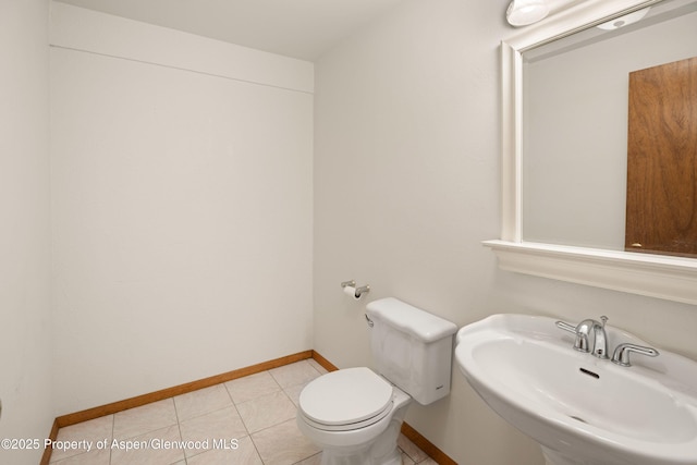 bathroom with tile patterned flooring, sink, and toilet