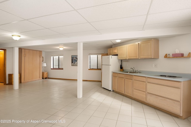 kitchen featuring white fridge, sink, light brown cabinets, and a paneled ceiling