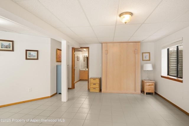 unfurnished bedroom with a paneled ceiling