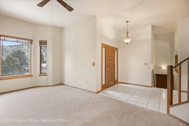 carpeted entrance foyer with ceiling fan