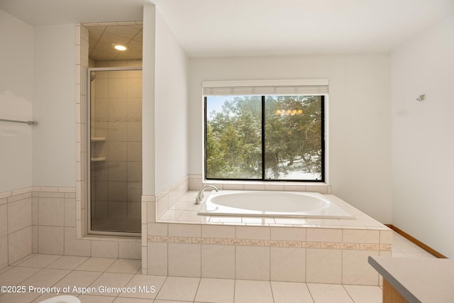 bathroom featuring tile patterned flooring, vanity, and shower with separate bathtub