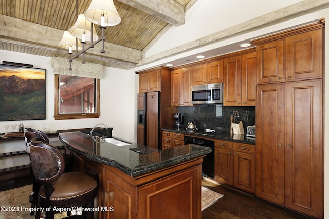 kitchen featuring black appliances, lofted ceiling with beams, a center island with sink, sink, and wood ceiling