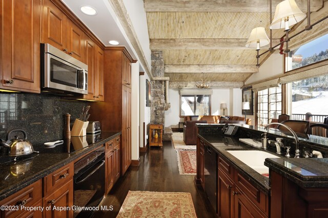 kitchen with backsplash, dark stone countertops, black appliances, and dark hardwood / wood-style floors