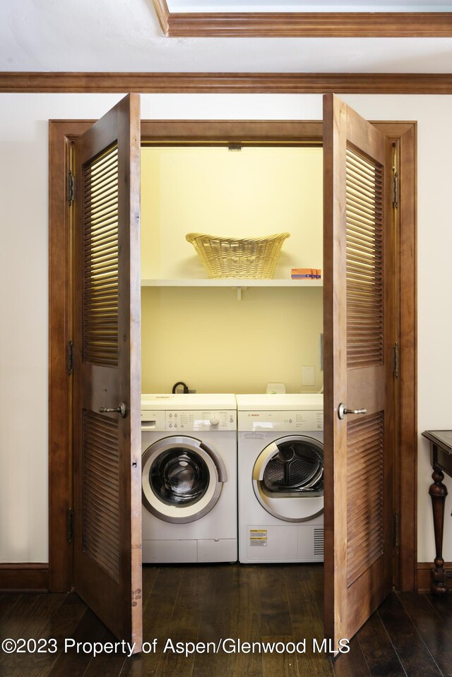 laundry room with washer and dryer and dark hardwood / wood-style floors